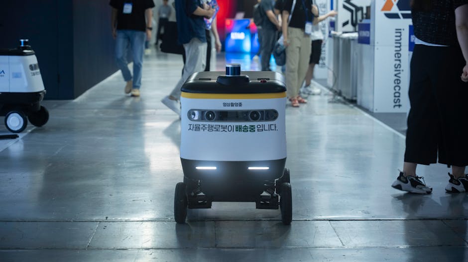 Autonomous delivery robot navigating indoors during a technology event.