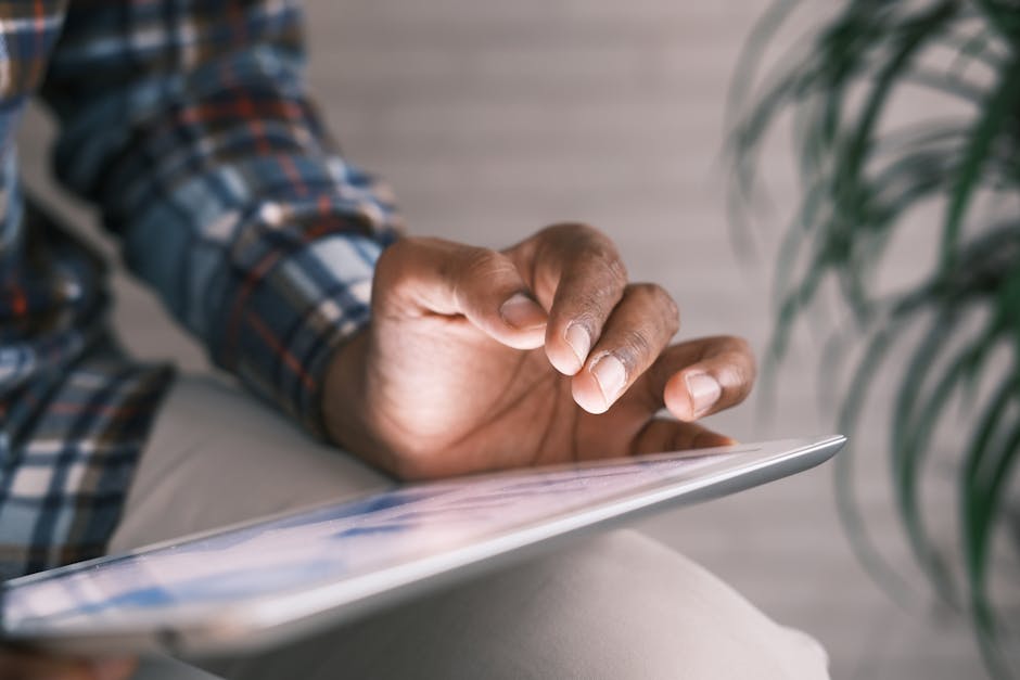 Close-up image of a person interacting with a tablet, showcasing modern technology use.