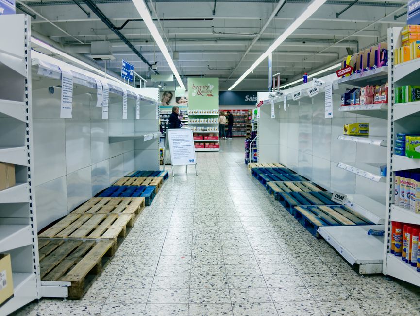 Empty supermarket shelves in Bielefeld, Germany, depicting a shortage or high demand situation.